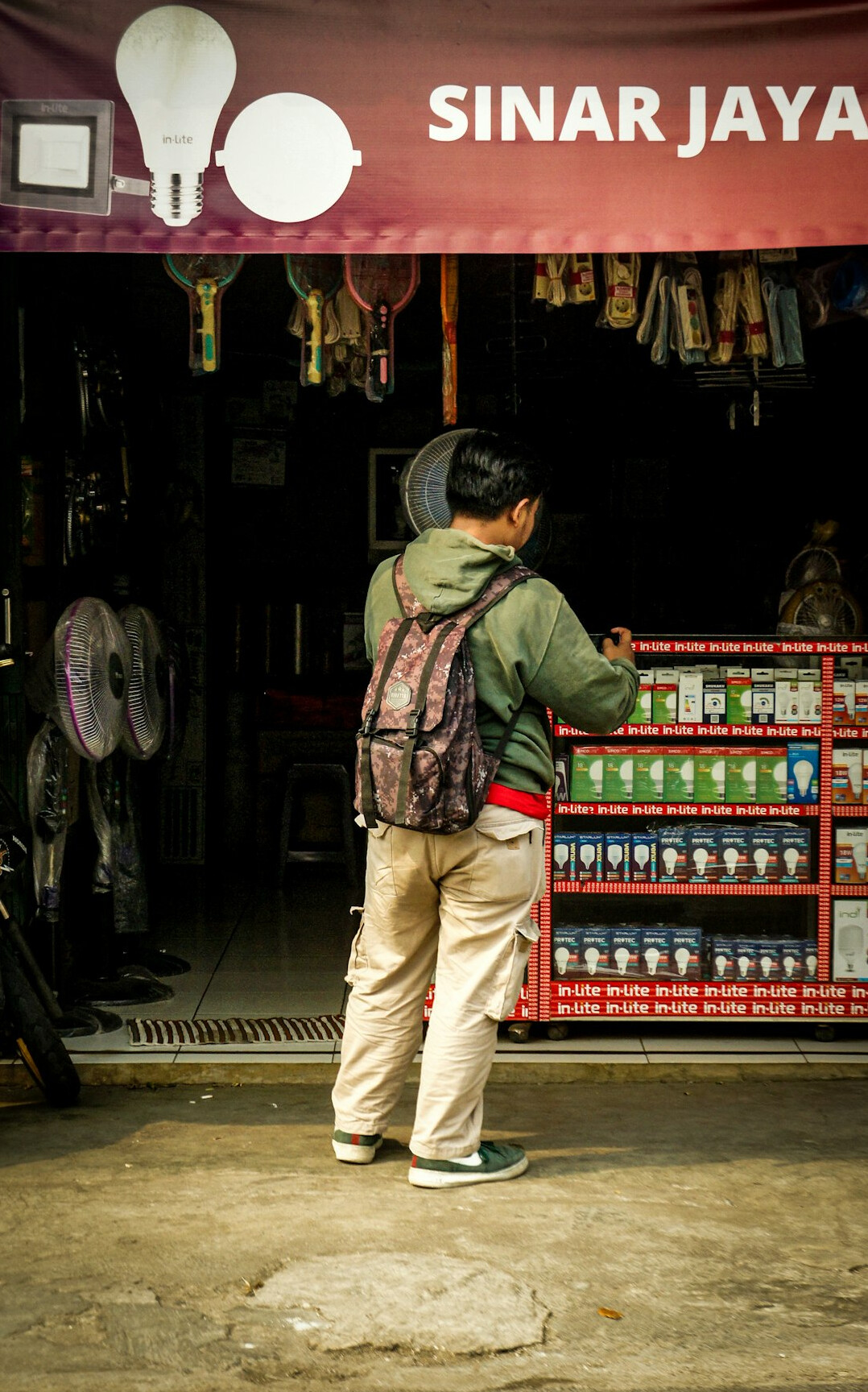 man with backpack in store